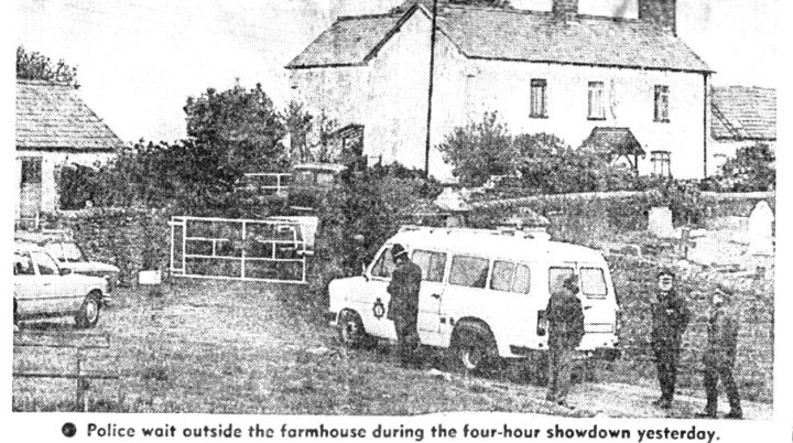Police outside the farmhouse during the demolition, December 1988